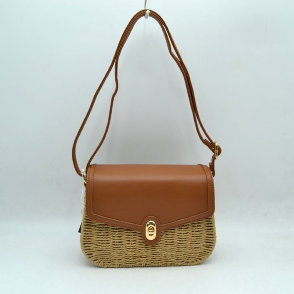 Brown Embrace warm-weather sophistication with this beautiful mixed-media shoulder bag. Effortlessly blending the rustic, organic charm of a woven straw basket body with a smooth, structured faux-leather flap enclosure, this bag is a must-have accessory for casual sunny days, resort vacations, or stylish weekend brunches. Its elegant silhouette offers a refined twist on classic beachwear aesthetics, transitioning perfectly from a day in the sun to an evening out.