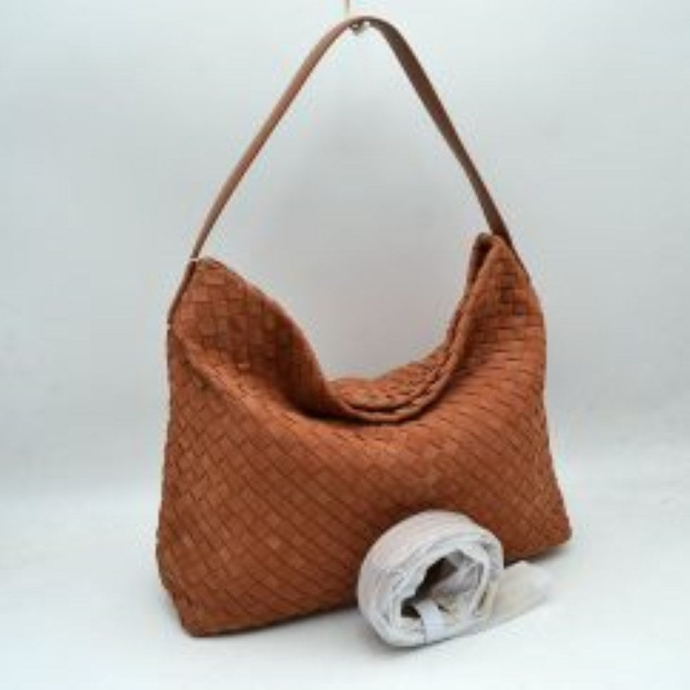 Brown This slouchy hobo bag showcases a textured woven pattern across its exterior, offering a refined look that is perfect for everyday use. The spacious main compartment provides ample storage for daily essentials, featuring a relaxed silhouette with a flat top shoulder strap for comfortable carrying. A separate, detachable secondary strap with metallic clasps is included, allowing for versatile styling options to suit your needs.