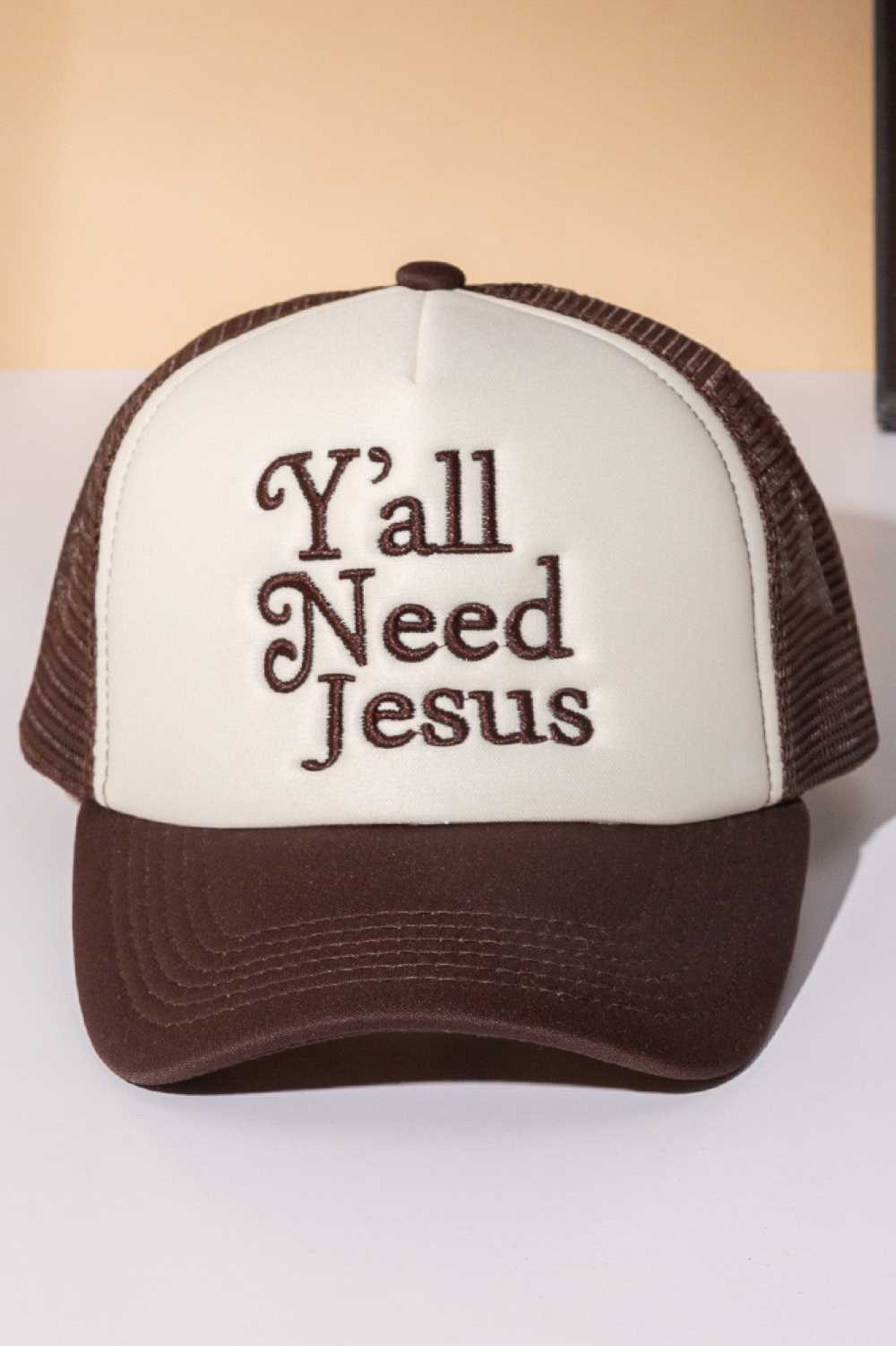 Brown Y'ALL NEED JESUS Letter Foam with Mesh Back Trucker Hat Baseball Cap Make a bold statement with this classic trucker cap featuring embroidered lettering across the front. Crafted from 100% polyester with a breathable mesh back panel, it's designed for all-day comfort and ventilation. The structured foam front provides durability and shape retention, while the adjustable snapback closure ensures a perfect fit for most head sizes. Whether you're heading to the gym, running errands, or making a fashion s
