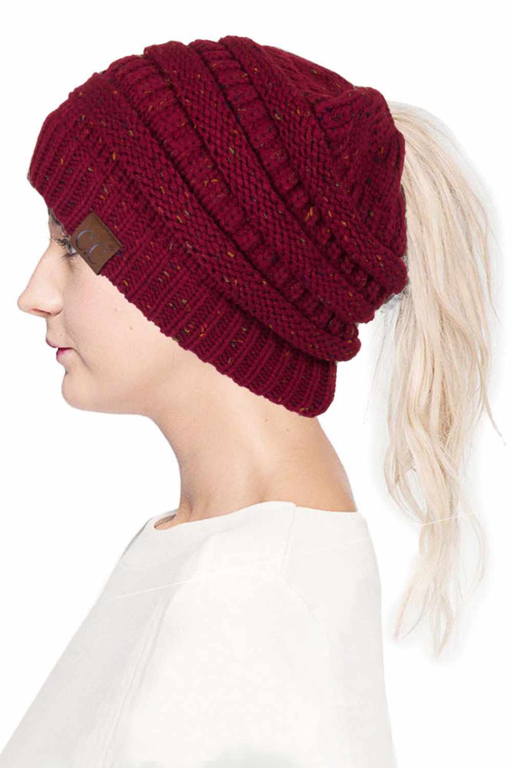 Burgundy The C.C Confetti Ponytail Messy Bun Beanie features a soft knit design with subtle confetti flecks for a fun, playful look. Designed with a convenient opening for ponytails or messy buns, it keeps you warm while allowing you to style your hair comfortably.