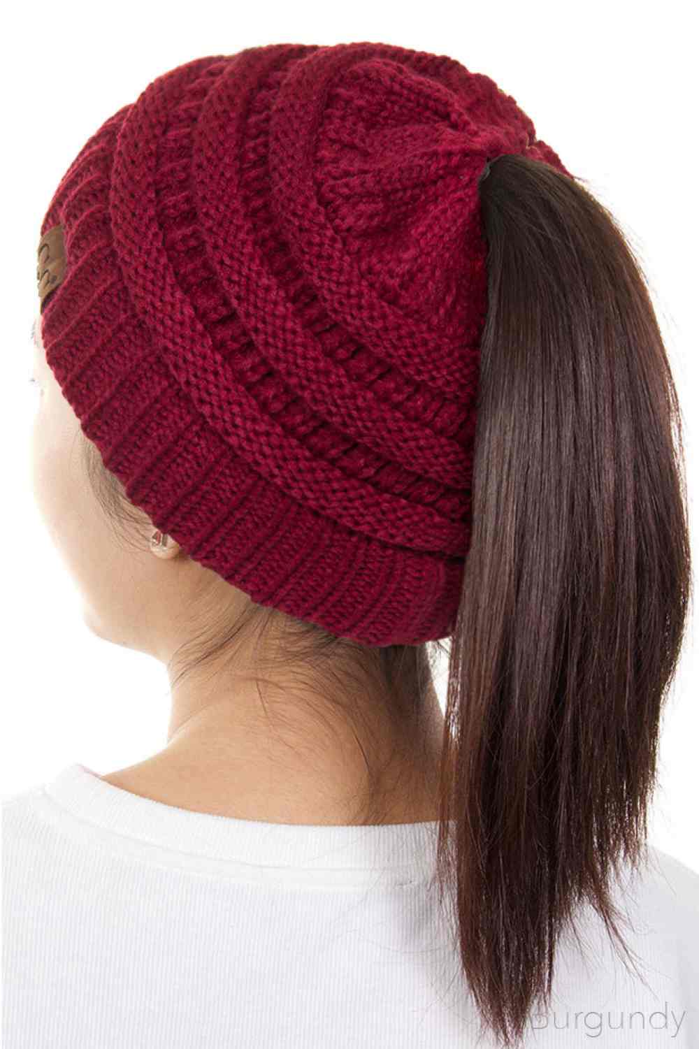 Burgundy The C.C Solid Color Ponytail Messy Bun Beanie combines comfort with versatility for effortless everyday style. Crafted from 100% soft acrylic, this beanie features an open crown design that accommodates ponytails and messy buns while keeping you warm. The one-size-fits-most construction ensures a secure, flattering fit for virtually anyone. Perfect for casual outings, workouts, or relaxed weekends, this practical accessory transitions seamlessly from season to season.