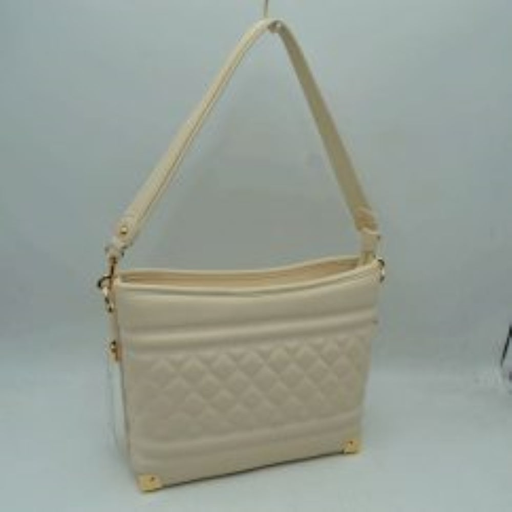 Butter cream This everyday shoulder bag features a structured silhouette highlighted by a quilted diamond pattern across the lower midsection and horizontal stitched ridges. Designed for practical daily use, it is equipped with a single flat shoulder strap secured to the sides by hardware attachments.
