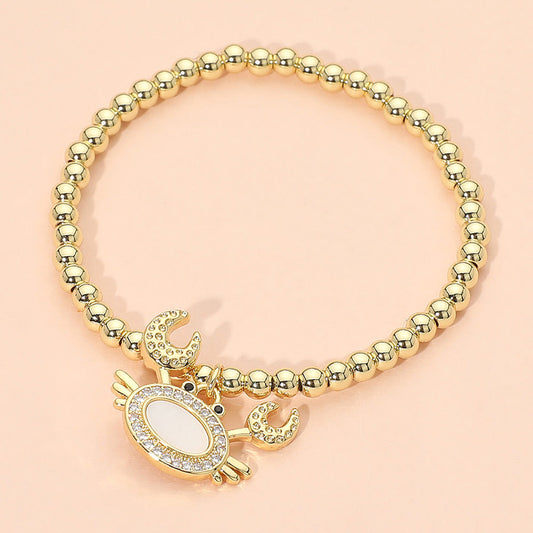 Madeline Love Gold, Mother of Pearl Stainless Steel Mother of Pearl CZ Stone Paved Crab Charm Beaded Stretch Bracelet - Jewelry