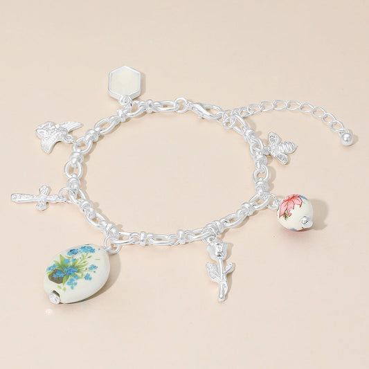 Madeline Love Green, Matte Silver Vintage Floral Ceramic Charm Metal Angel Flower Stem Honey Bee Charm Station Bracelet - Bracelets