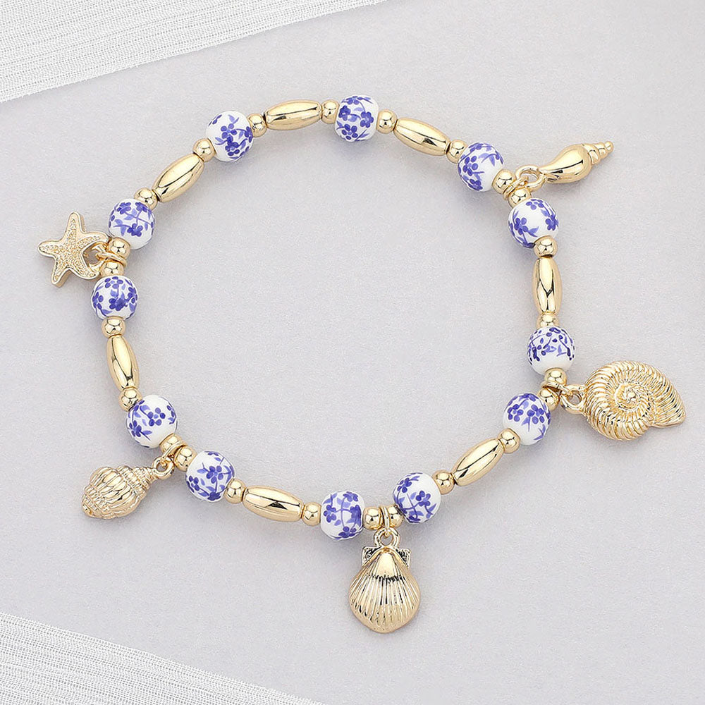 Madeline Love Blue, Gold Metal Shell Puka Shell Starfish Charm Station Ceramic Ball Beaded Stretch Bracelet - Bracelets