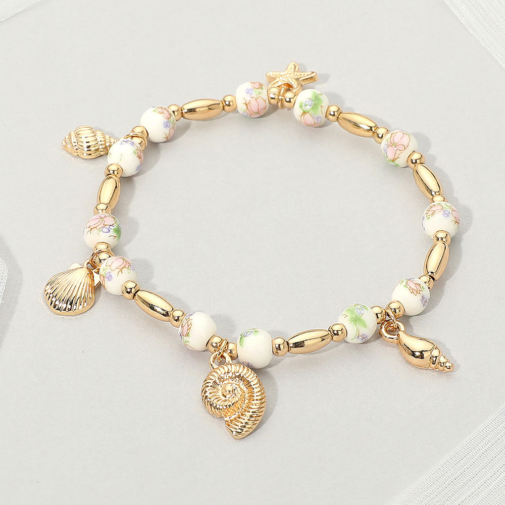Madeline Love Gold, Pink Metal Shell Puka Shell Starfish Charm Station Ceramic Ball Beaded Stretch Bracelet - Bracelets