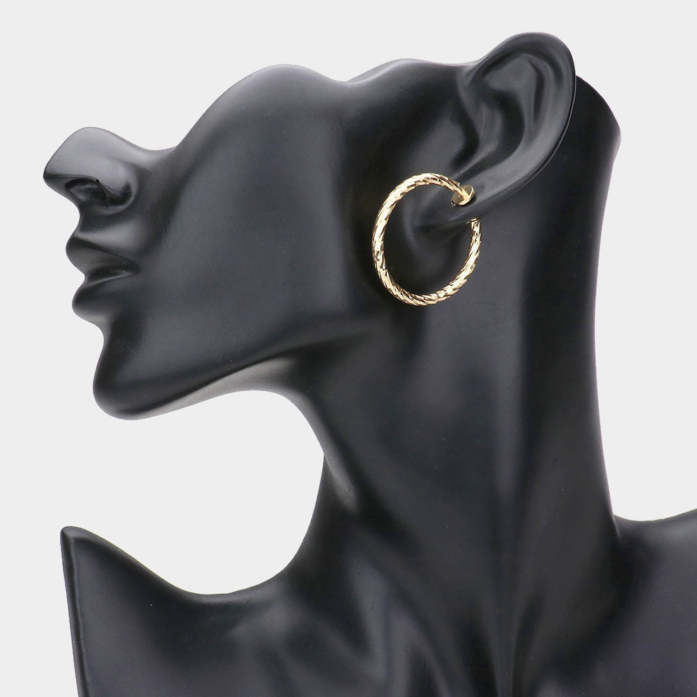 Madeline Love Gold 1.25" Textured metal hoop clip on earrings - desc
