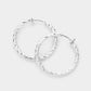 Madeline Love Silver 1.25" Textured metal hoop clip on earrings