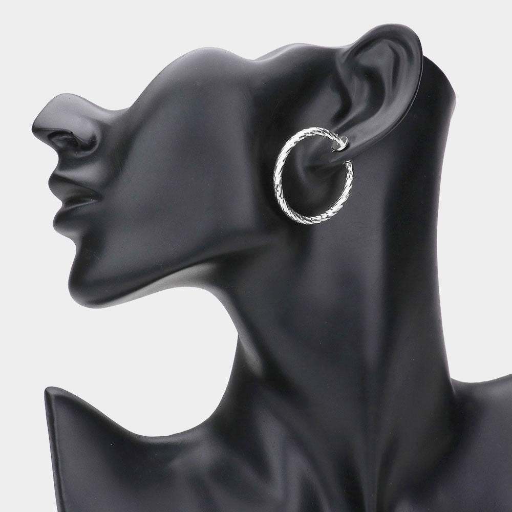 Madeline Love Silver 1.25" Textured metal hoop clip on earrings - desc