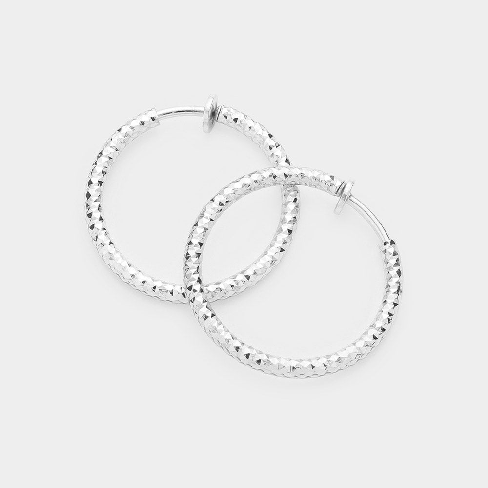 Madeline Love Silver 1.25" Textured Metal Hoop Clip on Earrings