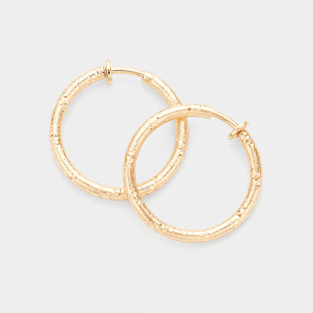 Gold 1.25 Inch Textured Metal Hoop Clip On Earrings