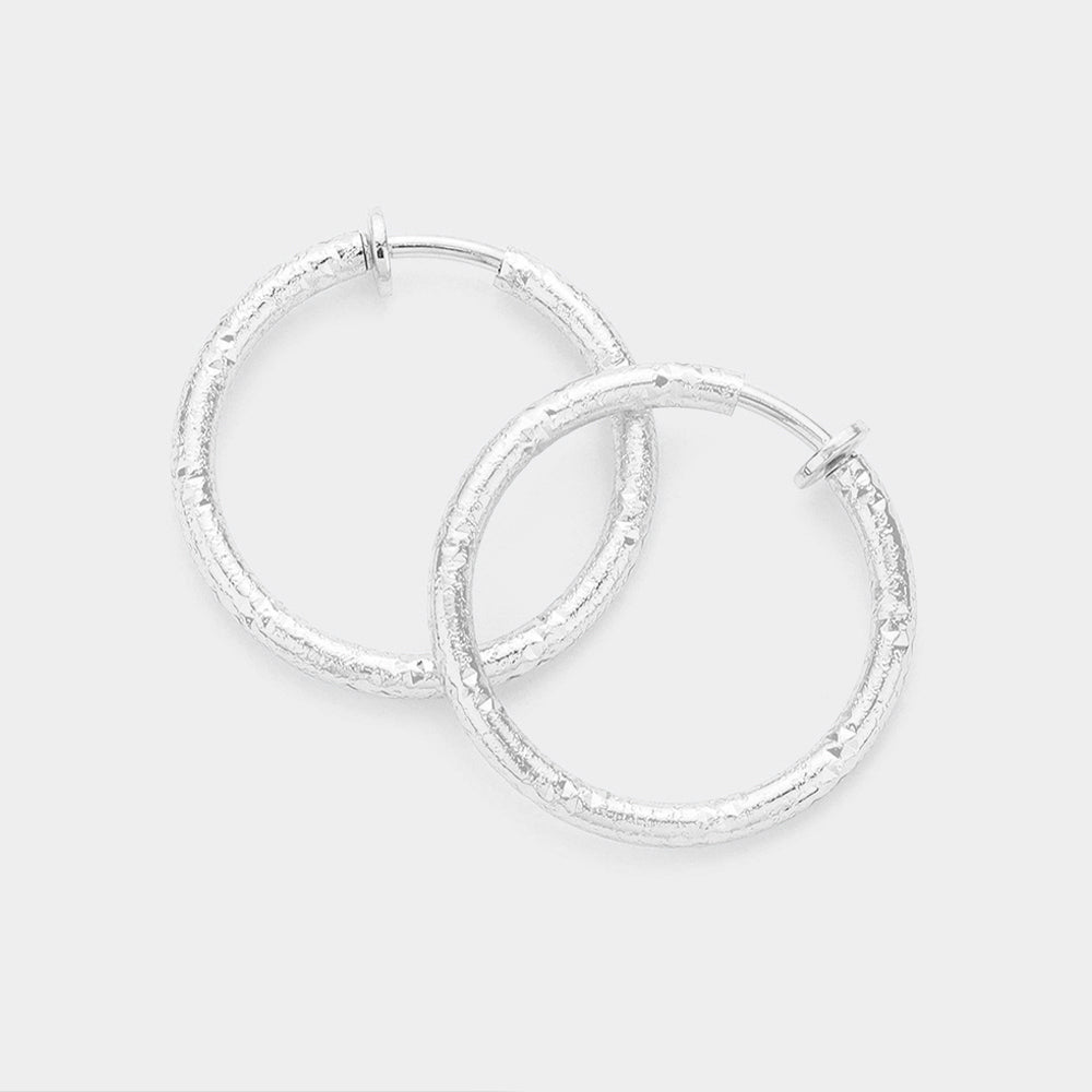 Silver 1.25 Inch Textured Metal Hoop Clip On Earrings