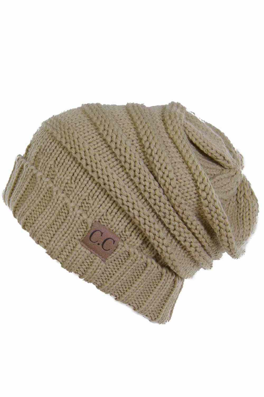 Camel Wrap yourself in warmth with this C.C Slouchy Knitted Beanie, crafted from 100% soft acrylic for ultimate comfort. The oversized silhouette and plush pom pom detail create a relaxed, on-trend look perfect for chilly days. Available in nine versatile colors—Beige, Berry, Dark Denim, Heather Gray, Ivory, Pistachio, Rose, Steel Blue, and Violet Purple—this beanie pairs effortlessly with any winter wardrobe. The ribbed knit construction ensures durability and a flattering fit.