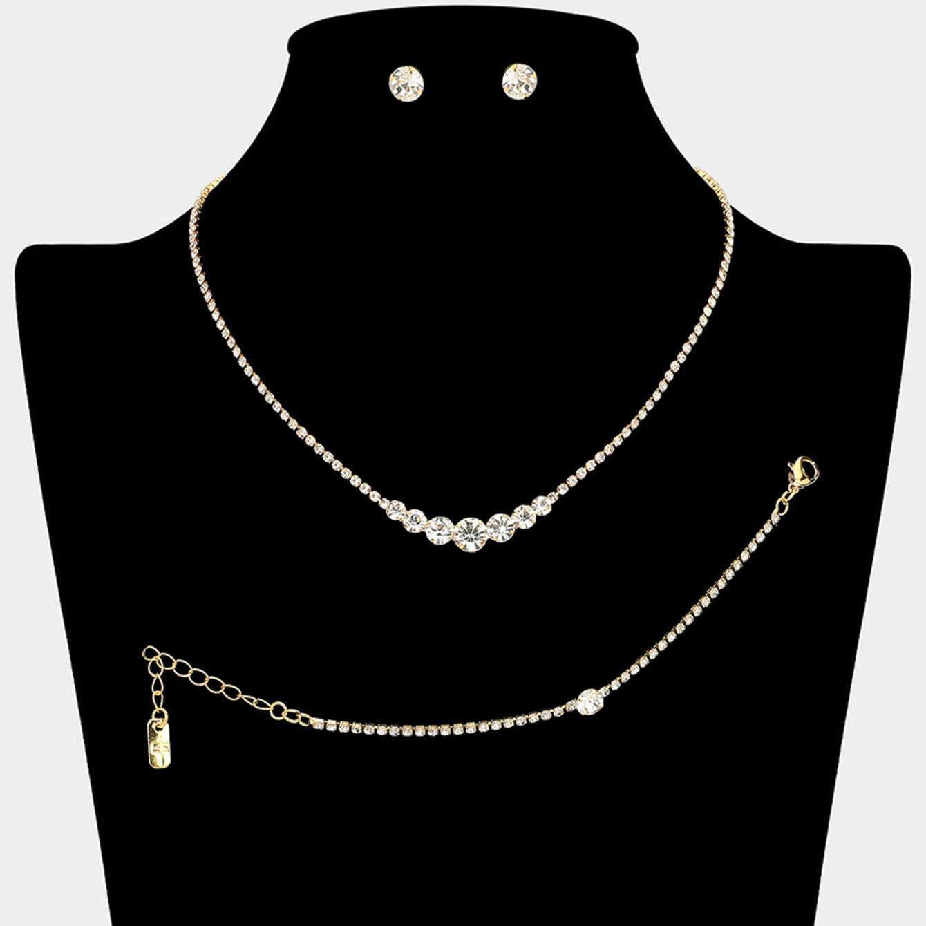 Clear Gold Timeless matching necklace, stud earring, and bracelet set designed with a clean round stone centerpiece for effortless elegance. Ideal for weddings, formal events, parties, and everyday special occasion styling. A versatile set that delivers refined sparkle and coordinated sophistication.