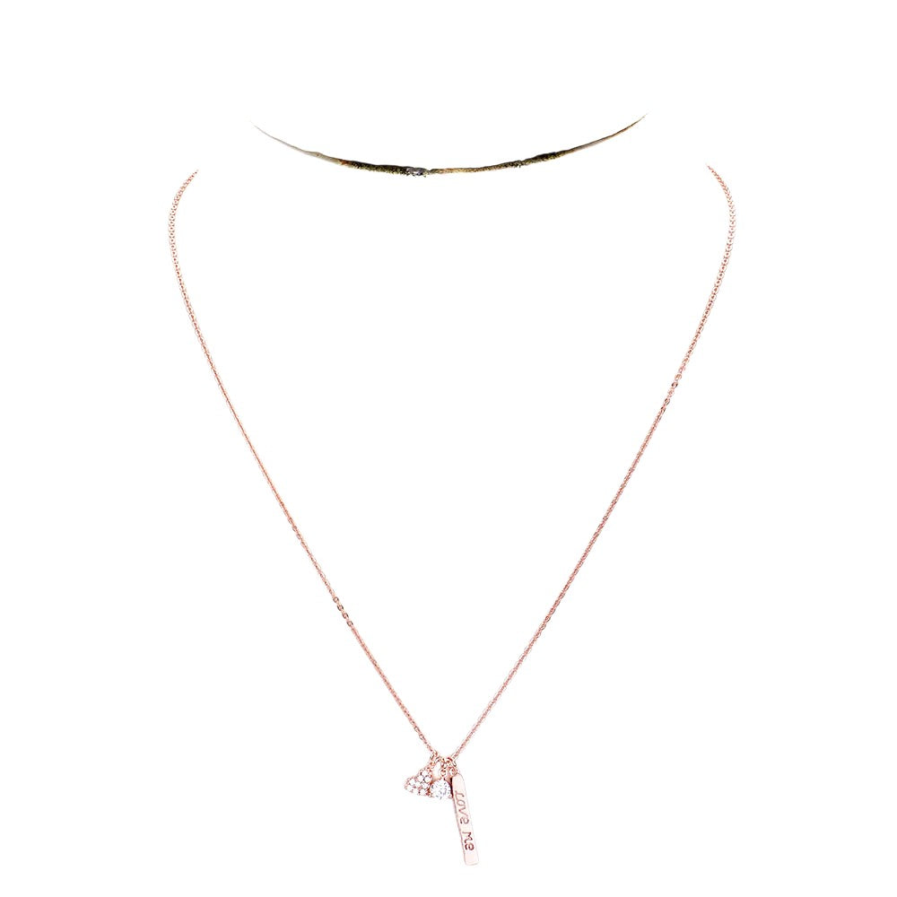 Clear Rose Gold Dipped CZ 'Love Me' Heart Pendant Necklace is the perfect accessory to show your love. The pendant is expertly crafted with cubic zirconia stones and dipped in gold for a stunning and durable shine. A beautiful and meaningful gift for any special occasion.
