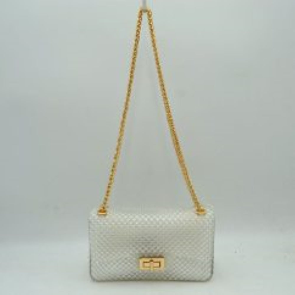 Clear This rectangular flap bag showcases a distinctive all-over bumpy textured design that adds unique tactile interest, making it a stylish choice for everyday use. The main storage compartment is safely secured by a front flap featuring a metallic twist-lock closure. Designed for easy carrying, the bag incorporates a long metallic chain shoulder strap fed through top eyelets, allowing it to rest comfortably on the shoulder throughout the day.
