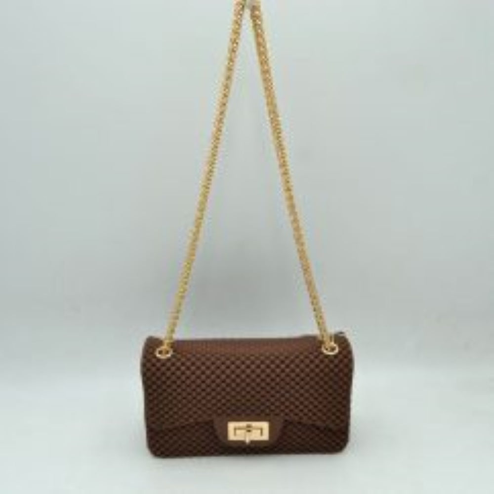 Coffee This rectangular flap bag showcases a distinctive all-over bumpy textured design that adds unique tactile interest, making it a stylish choice for everyday use. The main storage compartment is safely secured by a front flap featuring a metallic twist-lock closure. Designed for easy carrying, the bag incorporates a long metallic chain shoulder strap fed through top eyelets, allowing it to rest comfortably on the shoulder throughout the day.