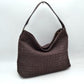 Coffee This slouchy hobo bag showcases a textured woven pattern across its exterior, offering a refined look that is perfect for everyday use. The spacious main compartment provides ample storage for daily essentials, featuring a relaxed silhouette with a flat top shoulder strap for comfortable carrying. A separate, detachable secondary strap with metallic clasps is included, allowing for versatile styling options to suit your needs.