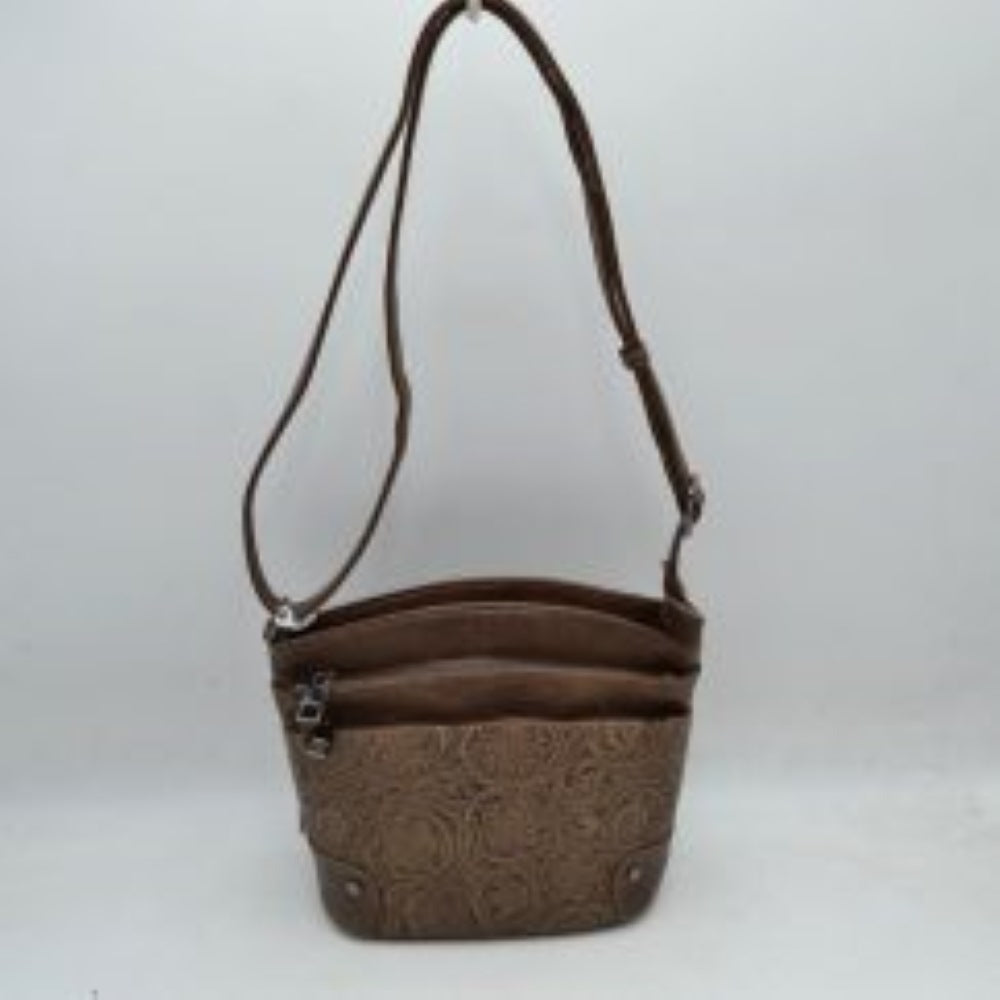 Coffee This functional crossbody bag features an elegant embossed floral pattern along the lower panel and a classic structured silhouette, ideal for daily organization. Designed with multiple storage options, it includes two main top-zippered compartments and a front zippered pocket with metallic hardware pull tabs to keep your essentials organized. A long, adjustable shoulder strap allows for comfortable, hands-free carrying over the shoulder or across the body.