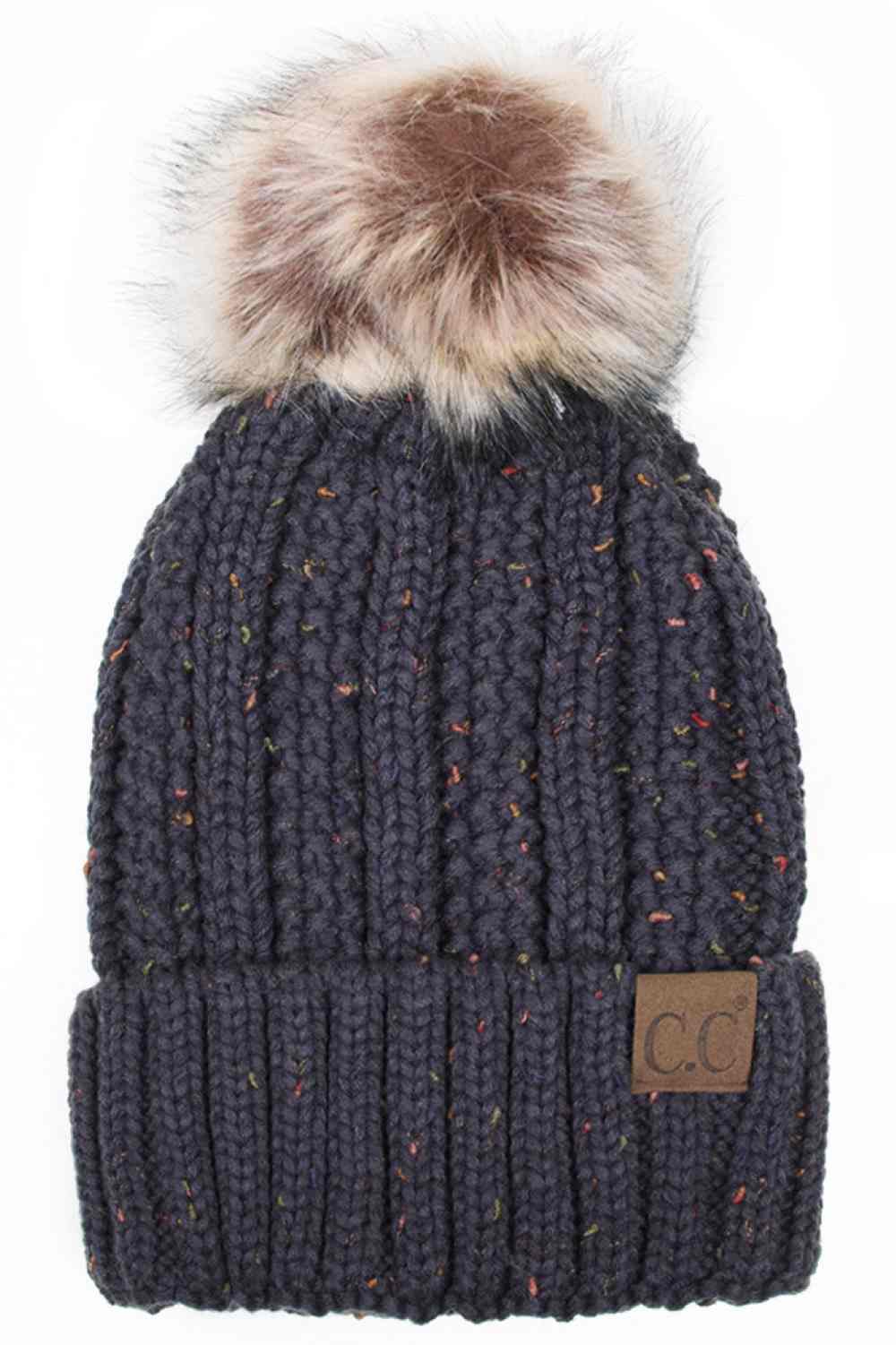 Dark Grey The C.C Fuzzy Fleece Lining Knit Beanie with Pom combines a soft knit exterior with a cozy fleece lining for extra warmth and comfort on chilly days. Finished with a fluffy pom-pom on top, it adds a cute and stylish touch to your winter wardrobe.