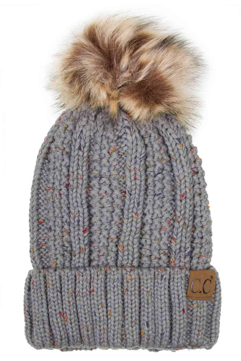 natural Grey The C.C Fuzzy Fleece Lining Knit Beanie with Pom combines a soft knit exterior with a cozy fleece lining for extra warmth and comfort on chilly days. Finished with a fluffy pom-pom on top, it adds a cute and stylish touch to your winter wardrobe.