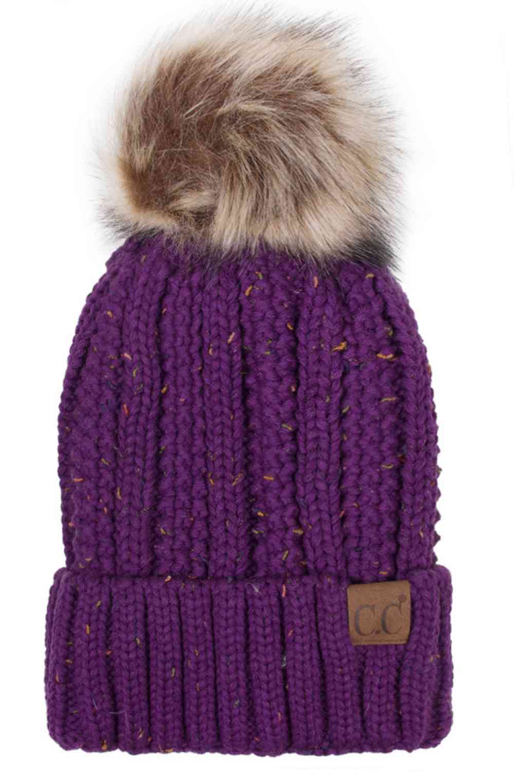 Purple The C.C Fuzzy Fleece Lining Knit Beanie with Pom combines a soft knit exterior with a cozy fleece lining for extra warmth and comfort on chilly days. Finished with a fluffy pom-pom on top, it adds a cute and stylish touch to your winter wardrobe.