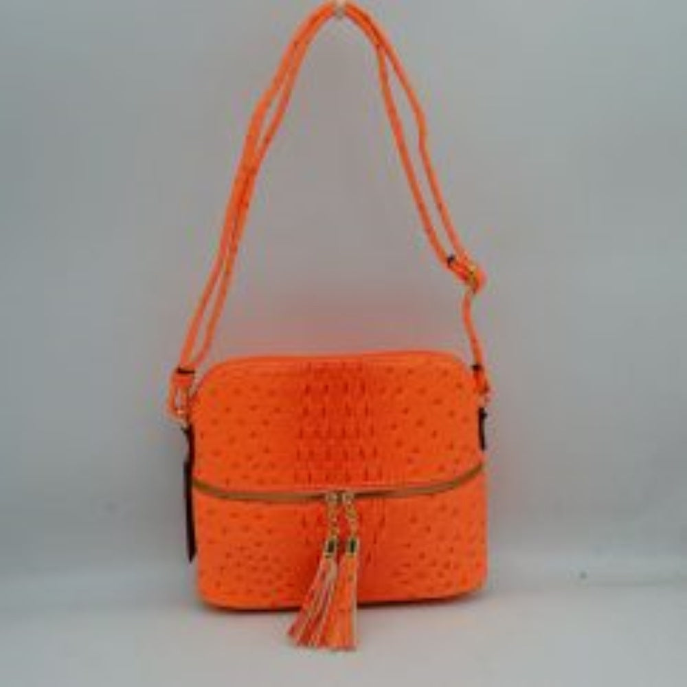 Coral This vibrant crossbody bag features a structured dome silhouette with a bold, ostrich-embossed texture in a striking neon orange hue, making it a standout accessory for everyday style. The front is detailed w/ an horizontal zipper compartment equipped w/ dual gold-tone zipper pulls finished with matching long tassel accents for a playful touch. Secured by a main top zipper closure to keep your essentials safe, it is completed w/ a long, adjustable shoulder strap for a comfortable, hands-free carry.