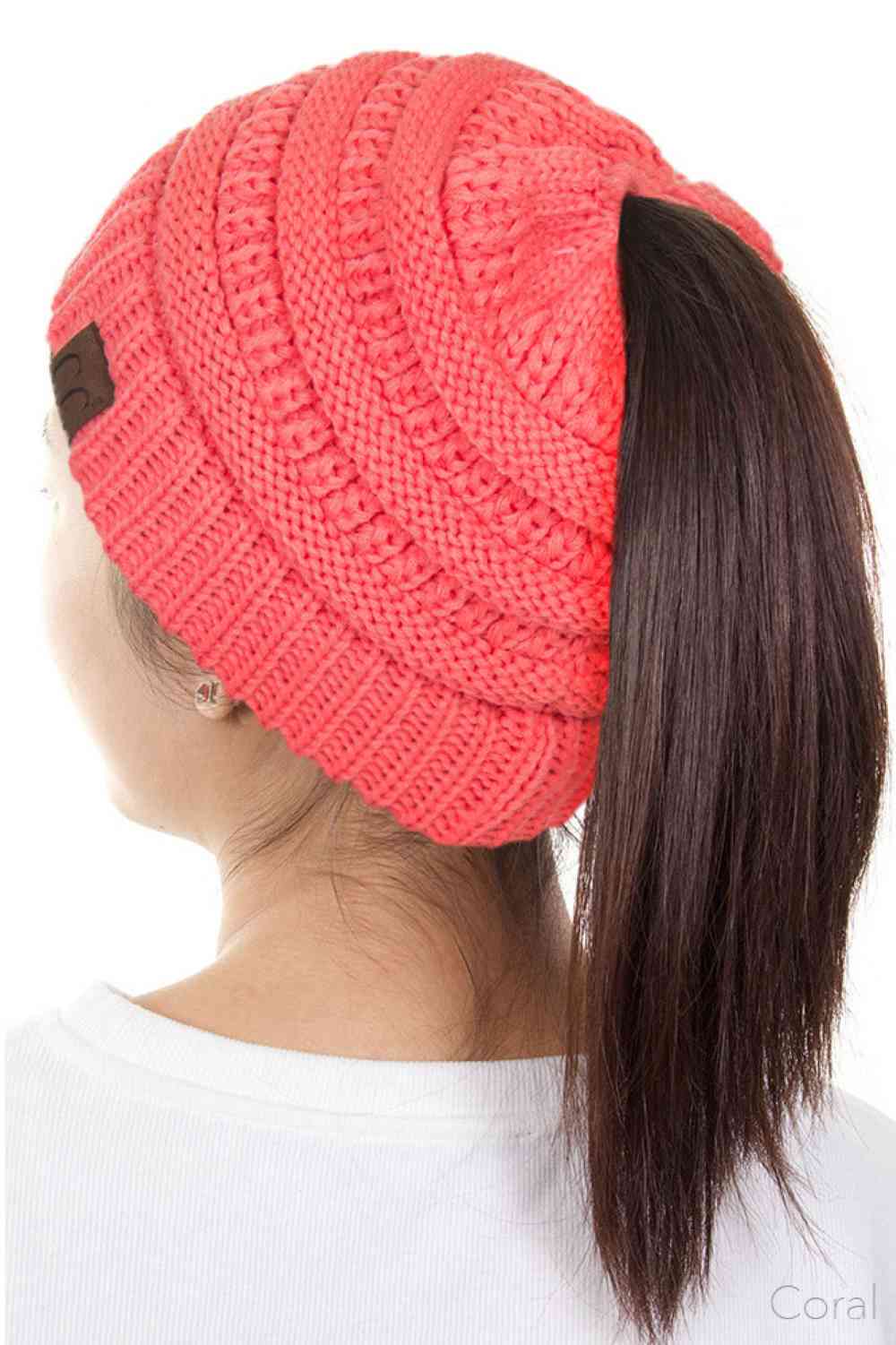 Coral The C.C Solid Color Ponytail Messy Bun Beanie combines comfort with versatility for effortless everyday style. Crafted from 100% soft acrylic, this beanie features an open crown design that accommodates ponytails and messy buns while keeping you warm. The one-size-fits-most construction ensures a secure, flattering fit for virtually anyone. Perfect for casual outings, workouts, or relaxed weekends, this practical accessory transitions seamlessly from season to season.