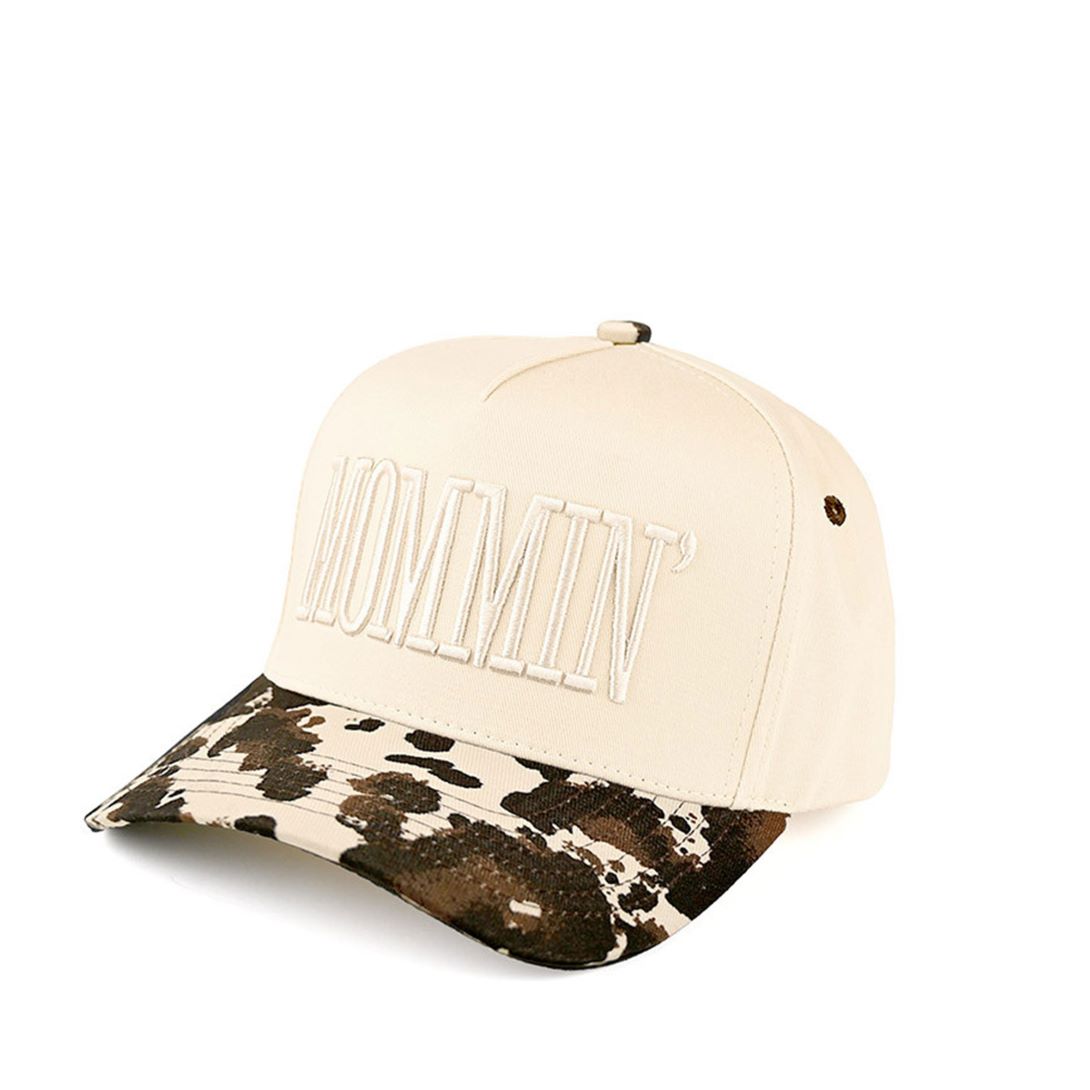 Cow Celebrate mom life in style with the C.C MOMMIN two-tone trucker hat, featuring clean letter embroidery for a bold yet laid-back look. With its classic baseball cap silhouette and breathable mesh back, this hat offers all-day comfort and an effortlessly cool finish for busy, on-the-go days.