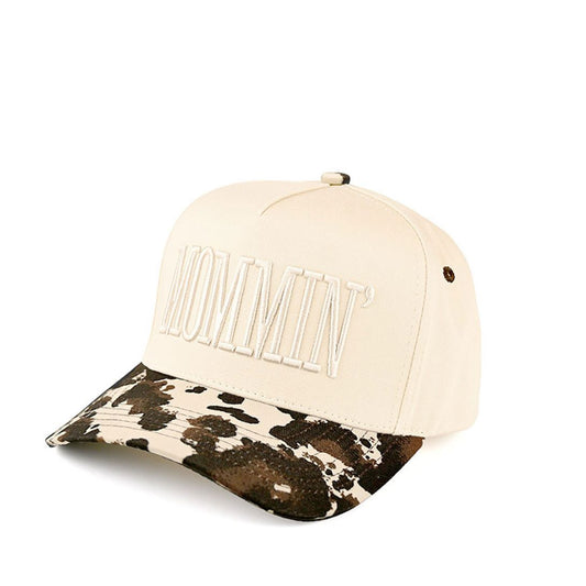Cow Celebrate mom life in style with the C.C MOMMIN two-tone trucker hat, featuring clean letter embroidery for a bold yet laid-back look. With its classic baseball cap silhouette and breathable mesh back, this hat offers all-day comfort and an effortlessly cool finish for busy, on-the-go days.