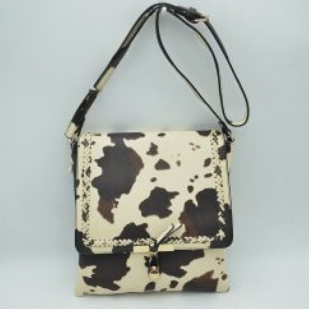 Cow Print Infuse your daily style with a touch of bohemian elegance with this classic flap crossbody bag. Boasting a softly structured, vertical square silhouette, this handbag stands out with intricate braided stitched detailing that frames the edges of the main top flap. A unique, polished metallic bar and dangling pull-tab closure anchor the front, offering a secure seal and a contemporary focal point.