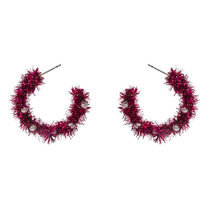 Celebrate the season with these festive tinsel hoop earrings, decorated with miniature ornament accents for a cheerful holiday touch. Lightweight and eye-catching, they’re perfect for adding playful flair to party outfits, winter gatherings, or seasonal celebrations.
