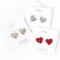 Crystal Rhinestone Paved Heart Stud Earrings bring a touch of elegance to any outfit. The sparkling rhinestones are intricately arranged in a heart-shaped design, adding a romantic and sophisticated charm to your look. Perfect for any occasion, these earrings are a must-have addition to any jewelry collection. 