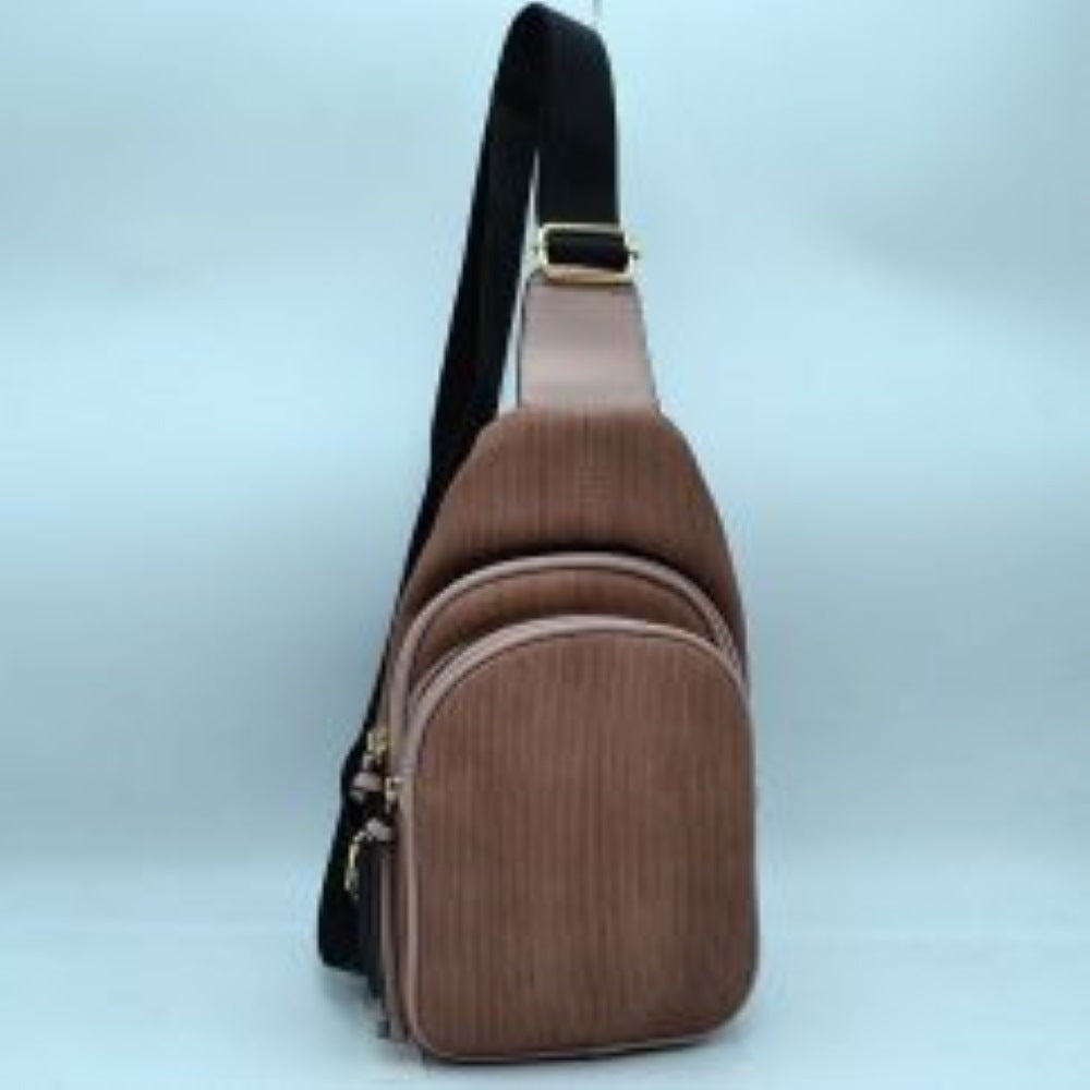 Dark-blush This practical sling bag features a textured, finely ribbed exterior w/ a tapered silhouette designed for comfortable everyday use. It offers organized storage compartments, including a curved main zippered section and a matching smaller front zippered pouch, both enhanced by elongated vertical tassel pulls hanging from the sliders. The bag is equipped w/ a single wide fabric shoulder strap attached to a smooth top panel & secured w/ a metallic adjustment buckle to easily customize the carrying 