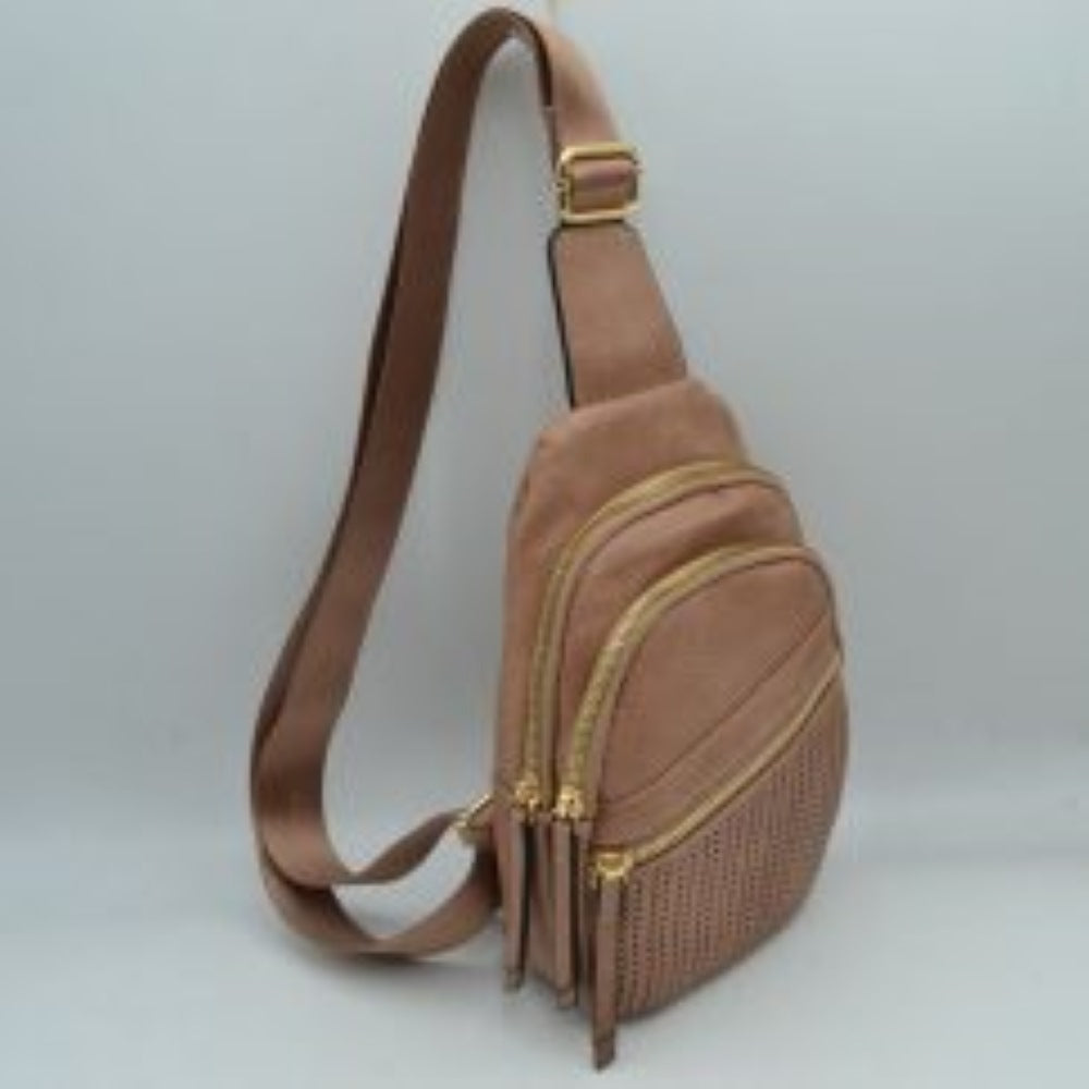 Dark-blush This functional sling bag features a textured, grained finish with a multi-tiered silhouette engineered for organized everyday use. It provides multiple distinct storage compartments, including a primary curved main section, an intermediate arched pouch, and a lower pocket featuring a horizontal zipper closure and a decorative perforated design. The bag is completed by a single wide