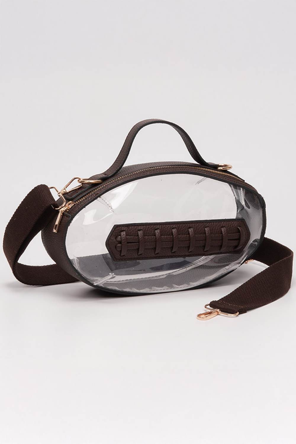 Dark Brown Carry your essentials in style with this unique football-shaped transparent crossbody bag. Perfect for stadium events, concerts, and outdoor gatherings, the clear PVC design lets you see everything inside while meeting venue security requirements. Measuring 11" x 6" x 4", it offers practical storage without bulk. The adjustable crossbody strap keeps your hands free, making it ideal for busy days out. Durable 100% PVC construction ensures long-lasting wear through countless adventures.