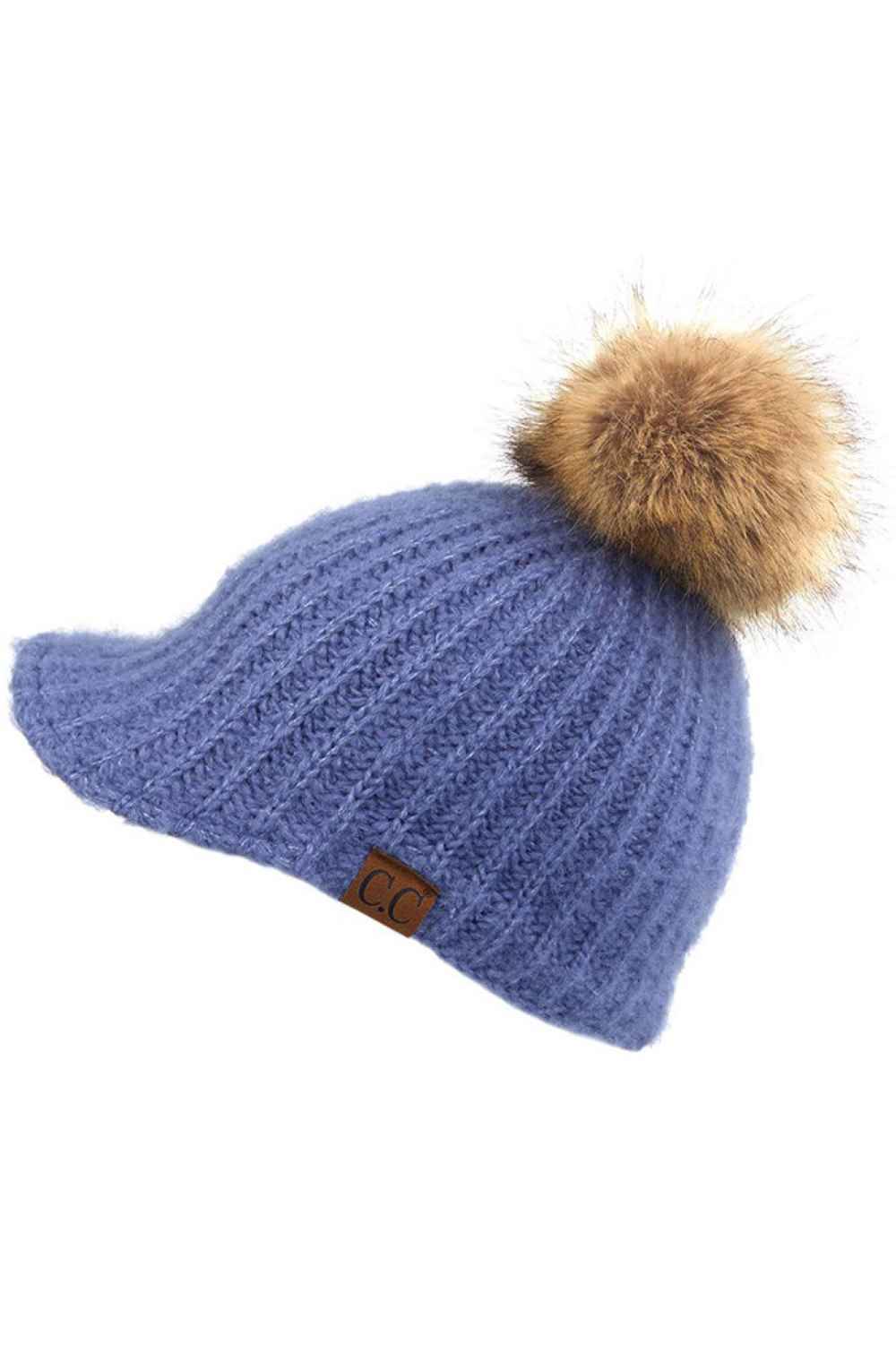 Dark Denim Stay cozy with this knitted brim beanie featuring a plush pom pom detail. Crafted from a soft blend of 75% acrylic, 22% polyester, and 3% spandex, this winter essential delivers warmth and comfort in a versatile style. Available in nine rich colors including Beige, Berry, Dark Denim, Heather Gray, Ivory, Pistachio, Rose, Steel Blue, and Violet Purple. The ribbed knit construction and faux fur pom add texture and visual interest to any cold-weather outfit. Hand wash and lay flat to dry for lasting