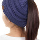 Dark Denim The C.C Solid Color Ponytail Messy Bun Beanie combines comfort with versatility for effortless everyday style. Crafted from 100% soft acrylic, this beanie features an open crown design that accommodates ponytails and messy buns while keeping you warm. The one-size-fits-most construction ensures a secure, flattering fit for virtually anyone. Perfect for casual outings, workouts, or relaxed weekends, this practical accessory transitions seamlessly from season to season.