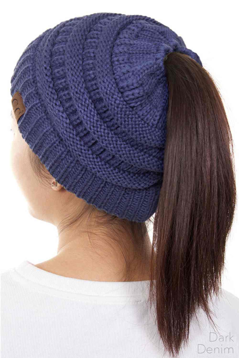 Dark Denim The C.C Solid Color Ponytail Messy Bun Beanie combines comfort with versatility for effortless everyday style. Crafted from 100% soft acrylic, this beanie features an open crown design that accommodates ponytails and messy buns while keeping you warm. The one-size-fits-most construction ensures a secure, flattering fit for virtually anyone. Perfect for casual outings, workouts, or relaxed weekends, this practical accessory transitions seamlessly from season to season.