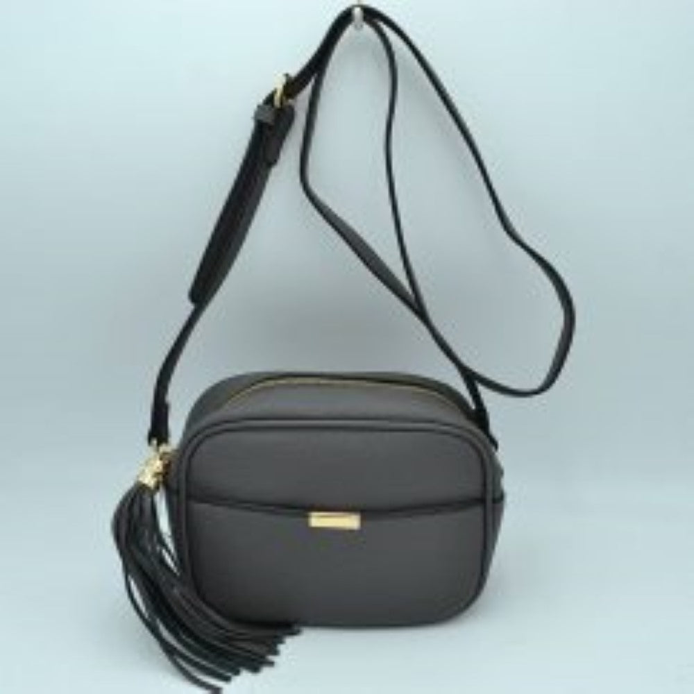 Dark gray This sophisticated crossbody bag features a structured camera-bag silhouette crafted from a textured pebbled faux leather in a neutral beige tone, making it a versatile addition to any wardrobe. The clean-lined front is detailed with a subtle open slip pocket highlighted by a polished, gold-tone metal hardware accent at the center. Secured by a smooth top-zipper closure, the bag is finished with an adjustable shoulder strap and a dramatic