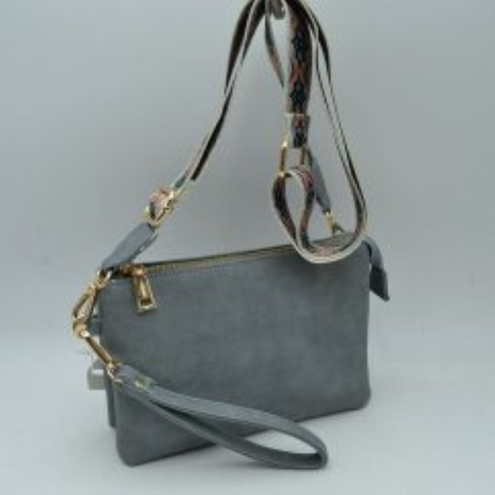 Dark gray This versatile clutch is designed for seamless everyday transition and features multiple carrying options to suit your style. It is equipped with secure top zipper compartments to keep your daily essentials safely organized and within reach. For carrying flexibility, the bag comes with both a matching wristlet loop and a wide, adjustable shoulder strap decorated with a detailed geometric woven pattern, both attaching easily via sturdy metallic clasps.