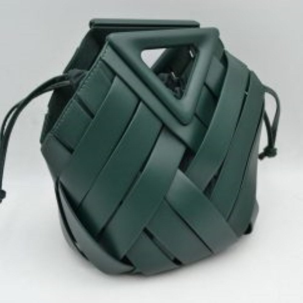 Dark-green This structural bucket bag features a distinctive geometric design composed of overlapping wide woven straps that create an eye-catching pattern, making it a unique statement piece for everyday use. A rigid triangular cutout shape forms an integrated top handle, while an additional long, flat shoulder strap extends from the upper frame for comfortable over-the-shoulder carrying.