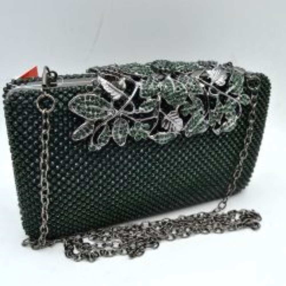 Dark-green Designed with a rigid rectangular silhouette, this sophisticated box clutch features a meticulously textured exterior composed of small, shimmering circular studs arranged in a uniform pattern. A detailed overlay consisting of metallic leaves and floral accents spans across the top closure, creating an elegant focal point while securing the main storage compartment. A matching link chain strap attaches seamlessly to the top edges