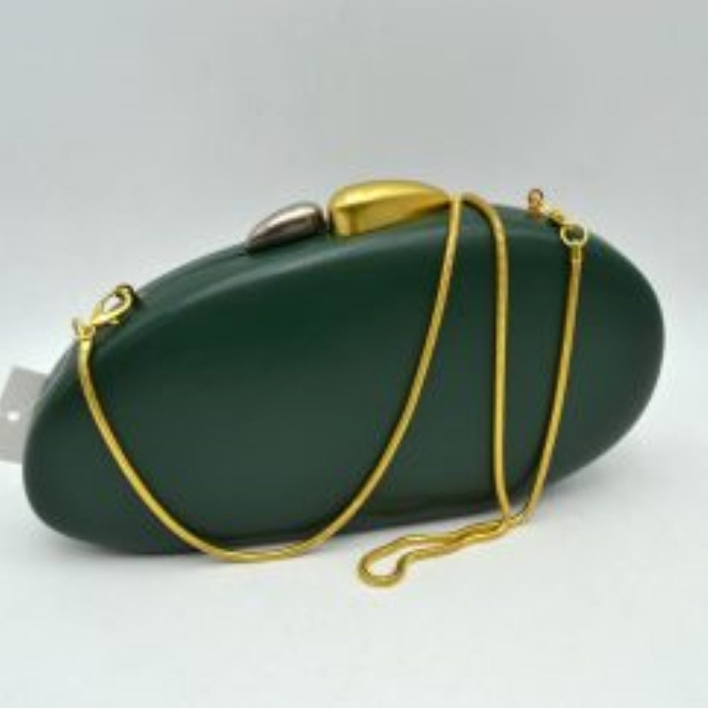 Dark-green This structured hardcase clutch bag features a smooth, rounded oval silhouette designed as a sleek accessory for everyday use. Its single interior storage compartment is secured with a rigid frame closure, accented at the top by a distinctive, asymmetrical two-tone sculptural clasp. A slender, matching metallic snake chain strap connects to small loop anchors on either side via clasp attachments, offering convenient options for hands-free shoulder or crossbody styling.