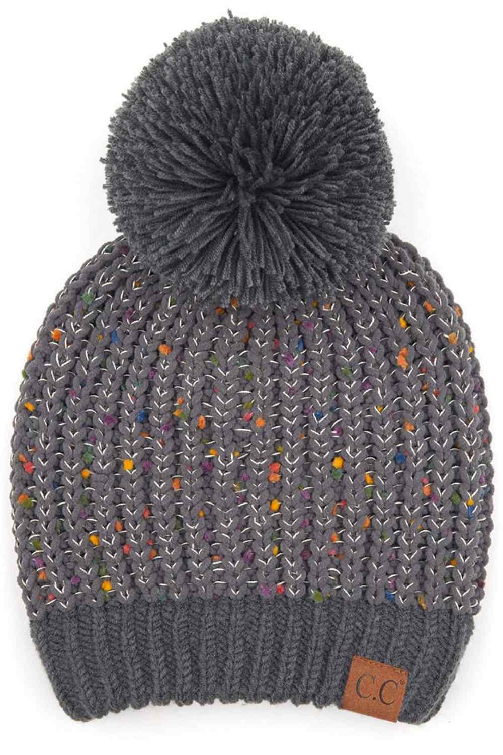 Dark Gray Elevate your winter wardrobe with this C.C Confetti Chenille Knit Pom Beanie, crafted from a premium blend of 50% acrylic, 43% polyester, and 7% nylon for durability and comfort. The soft chenille knit texture pairs beautifully with a cozy pom detail, making it perfect for both indoor and outdoor wear.