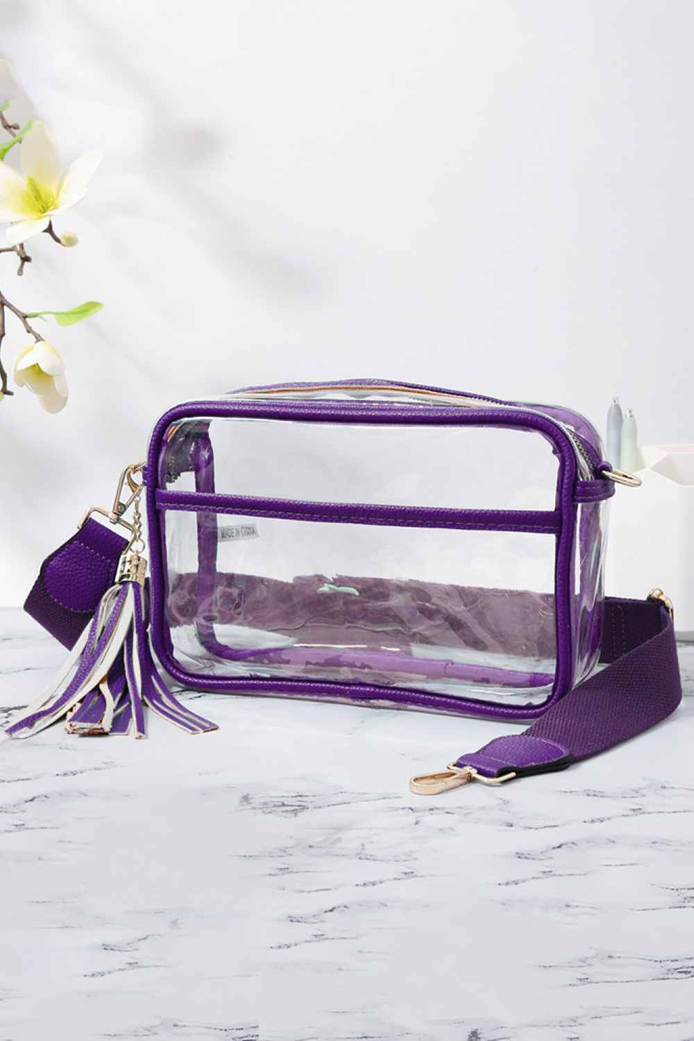 Dark Purple Clear PU Cross Body Camera Bag offers a sleek, transparent design crafted from durable polyurethane, providing both style and protection for your camera gear. Its crossbody strap ensures comfortable, hands-free carrying, while the clear material allows quick visibility of contents for easy access. Ideal for photographers seeking a practical yet modern solution to transport and safeguard their equipment.