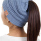 Denim The C.C Solid Color Ponytail Messy Bun Beanie combines comfort with versatility for effortless everyday style. Crafted from 100% soft acrylic, this beanie features an open crown design that accommodates ponytails and messy buns while keeping you warm. The one-size-fits-most construction ensures a secure, flattering fit for virtually anyone. Perfect for casual outings, workouts, or relaxed weekends, this practical accessory transitions seamlessly from season to season.