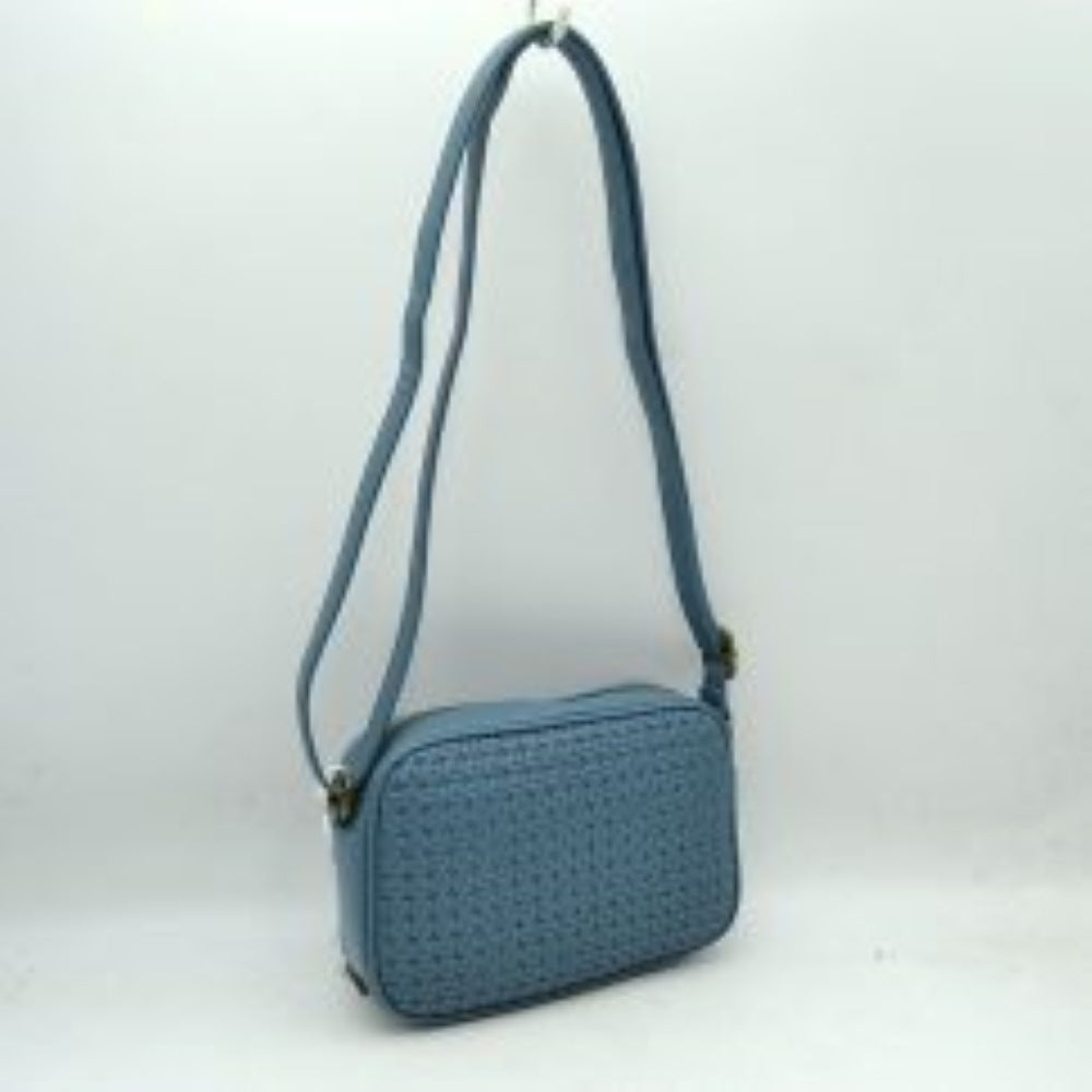 Denim This stylish crossbody bag combines a smooth, classic black exterior with an intricate woven front panel, offering a textured and sophisticated look for everyday use. Its compact, rectangular camera-bag silhouette features a secure top zipper closure with gold-tone hardware to keep your daily essentials safe and organized. Completed with a long, matching adjustable shoulder strap, this versatile bag can be styled comfortably over the shoulder or across the body for hands-free convenience.