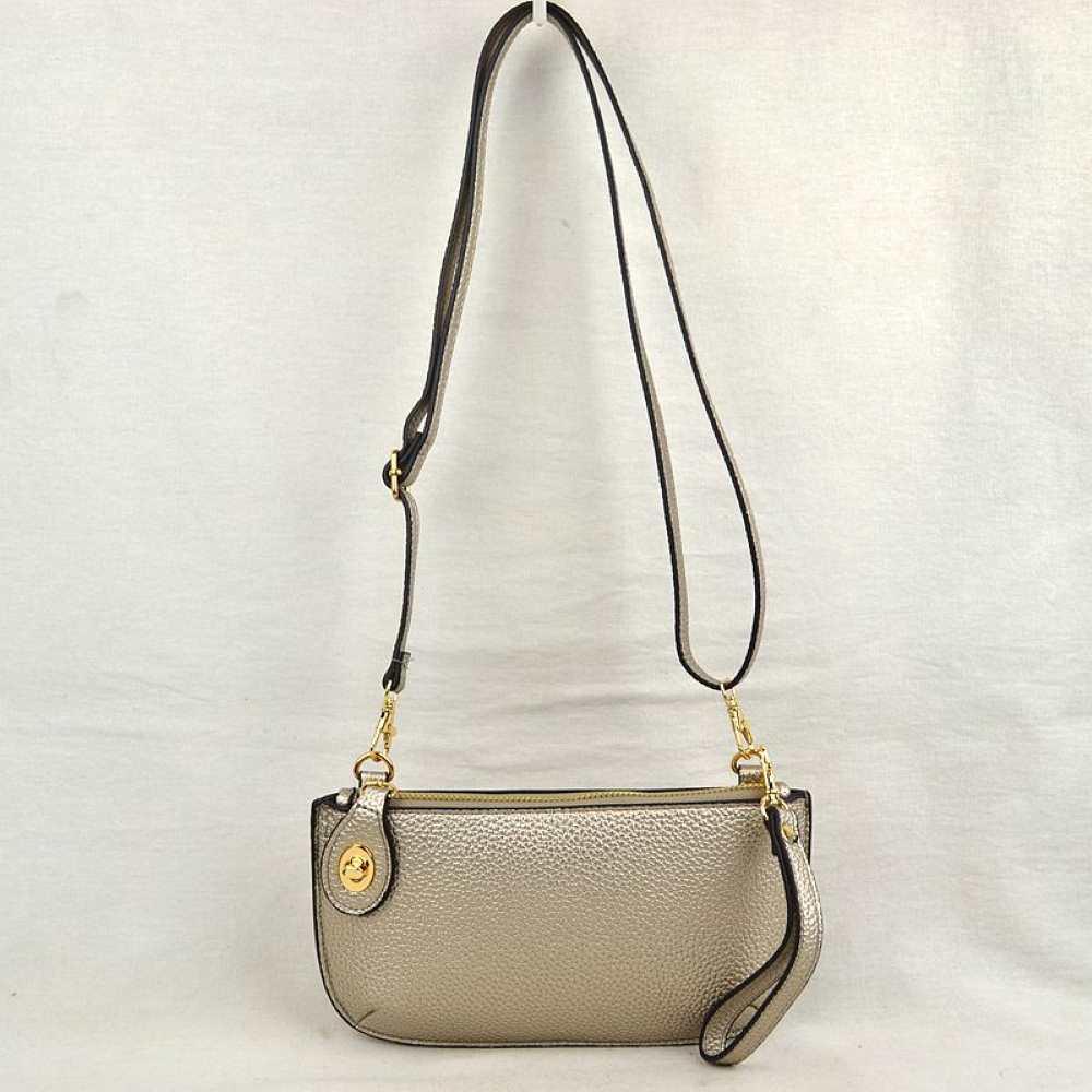 desert-Dust This versatile everyday bag features a compact pebbled textured body with a slightly curved base silhouette. Designed for organized daily or evening use, the main storage compartment is secured by a top zipper closure and accented with a small decorative metallic turn-lock detail on the side panel. It offers multiple carrying options, equipped with a long, adjustable crossbody shoulder strap and a shorter matching wristlet loop