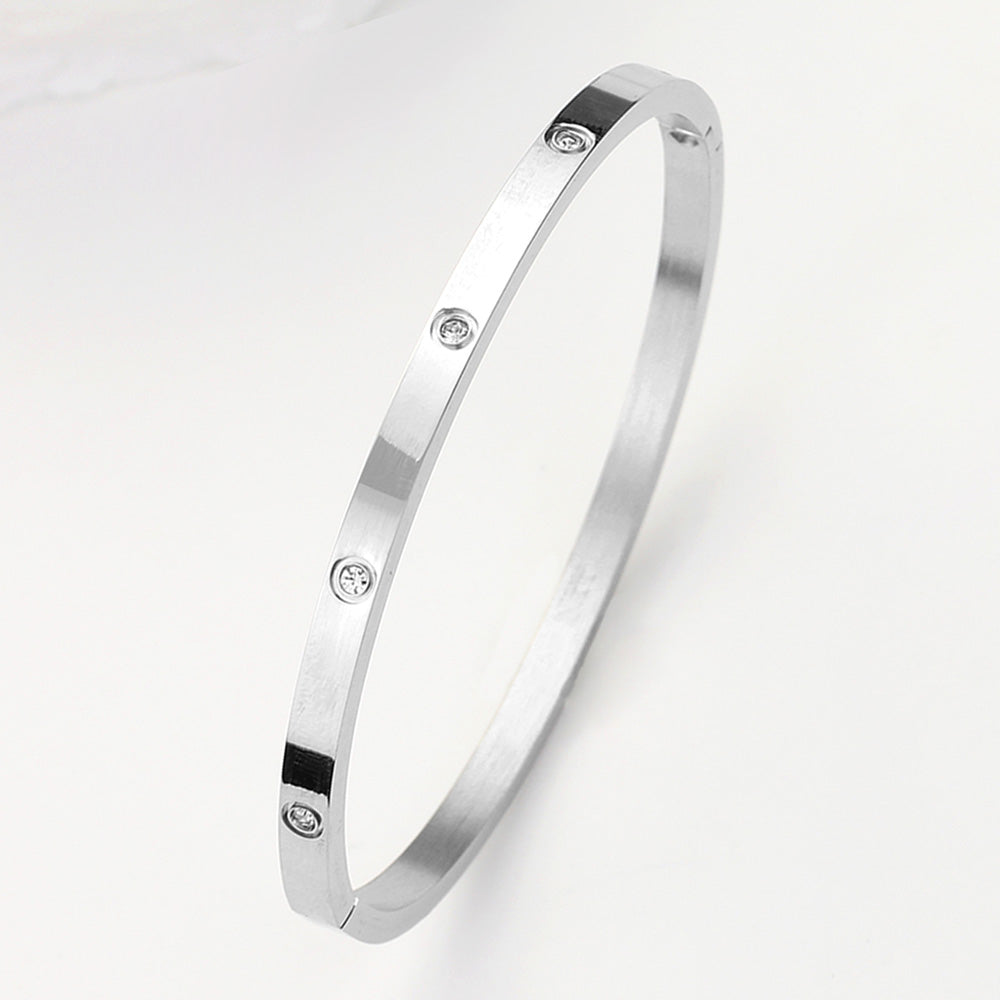 Madeline Love Silver Stainless Steel CZ Stone Embellished Bangle Bracelet - Bracelets
